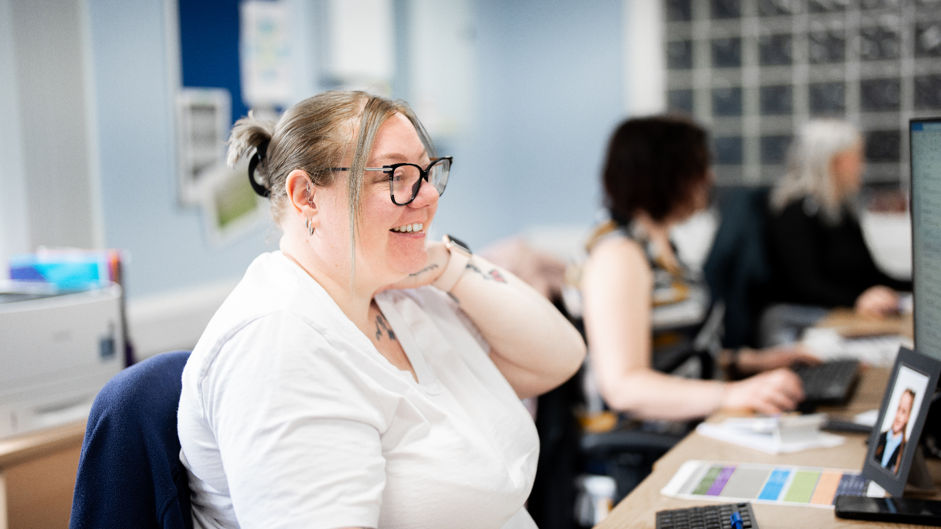 Jenkar ops team member smiling at her desk after AI workflows went live